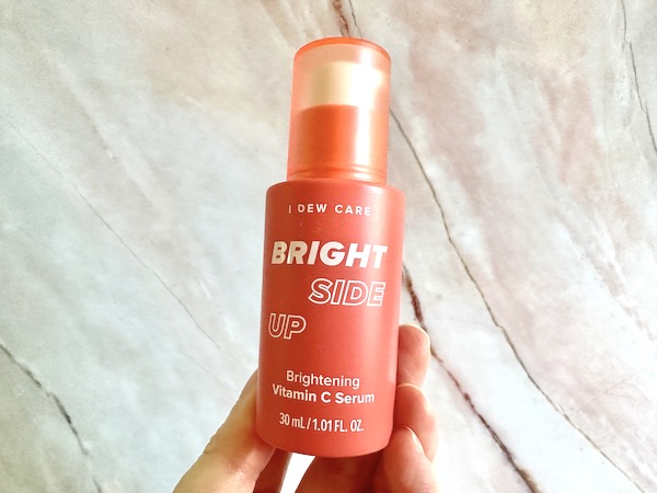 I Dew Care Bright Side Up Brightening Vitamin C Serum, handheld.