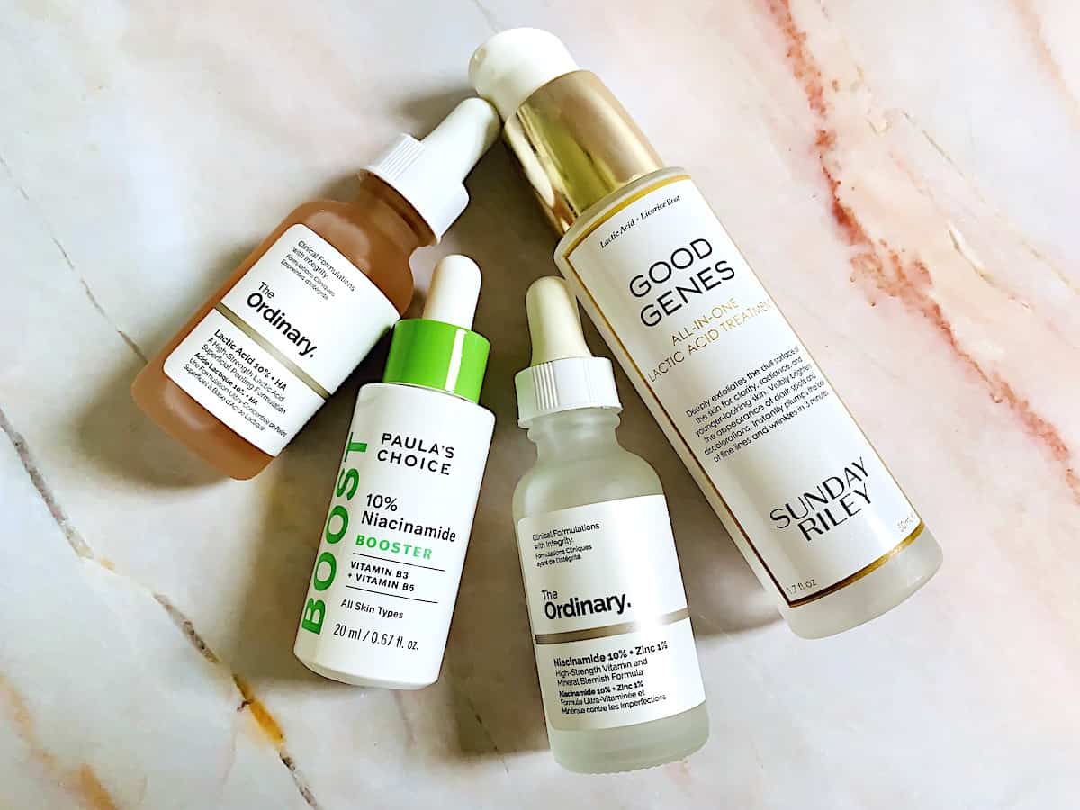 The Ordinary Niacinamide and Lactic Acid Serums, Paula's Choice 10% Niacinamide Booster, and Sunday Riley Good Genes All-In-One Lactic Acid Treatment