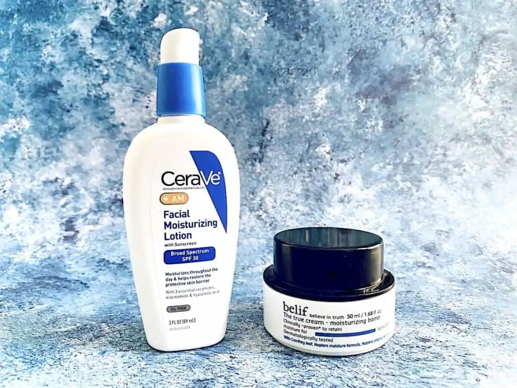 CeraVe AM Facial Moisturizing Lotion with SPF 30 and Belif The True Cream Moisturizing Bomb on blue background