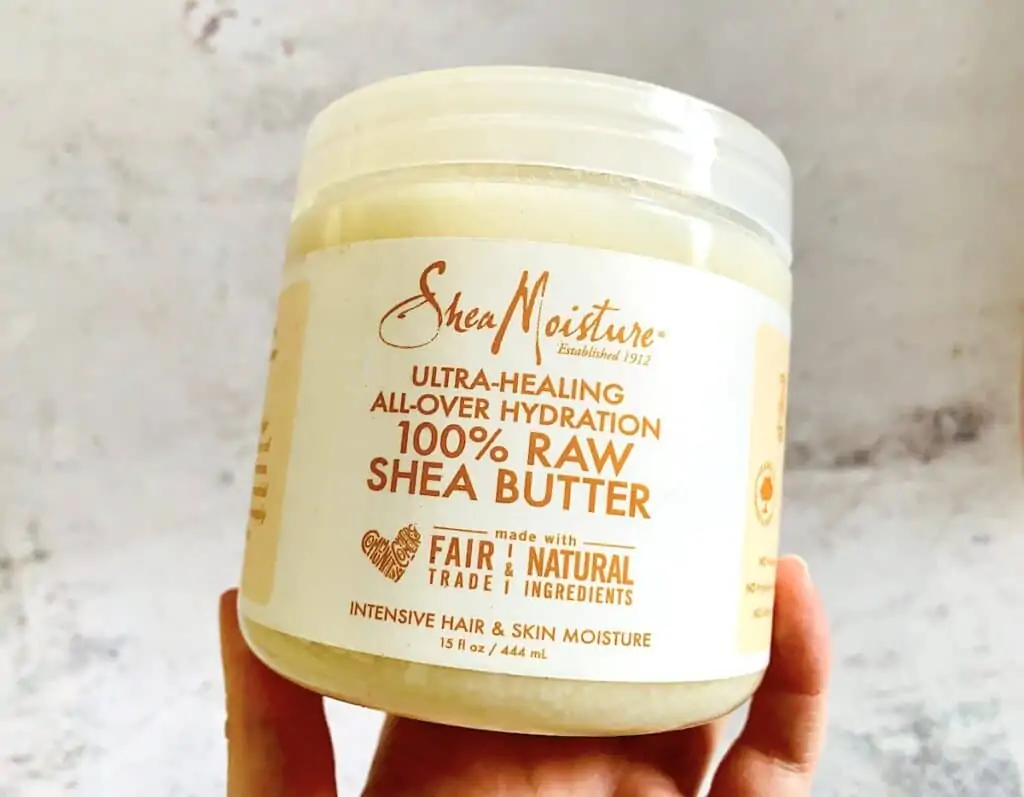 Shea Moisture 100% Raw Shea Butter held by hand