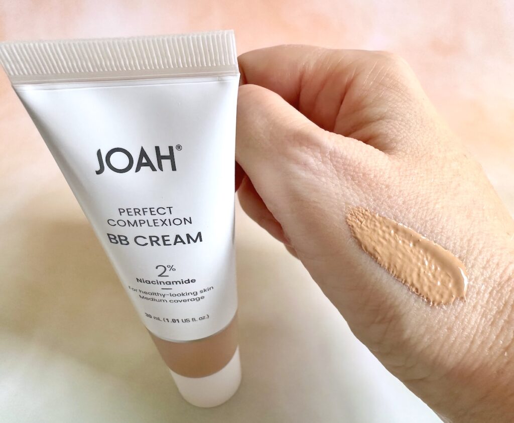 Joah Perfect Complexion BB Cream in the shade Light With Cool Undertones, tube next to sample on hand.