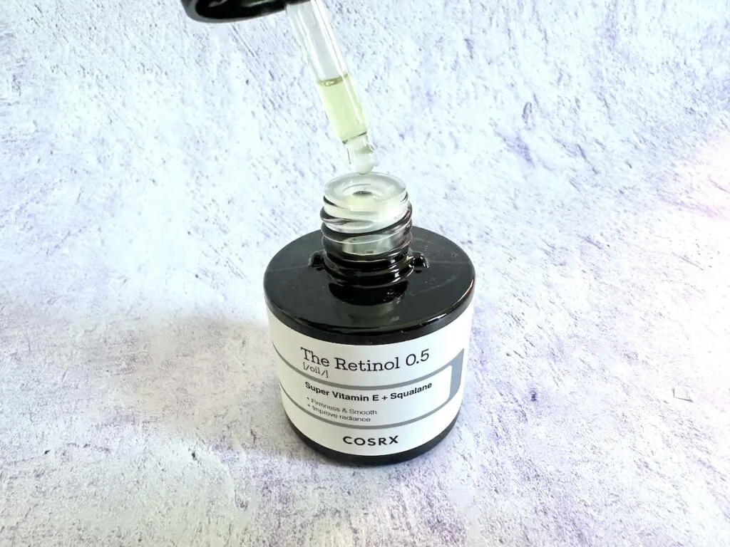 COSRX Retinol 0.5 Oil, open bottle with filled applicator dropper.